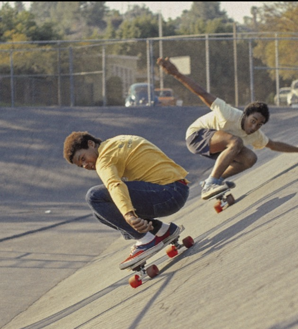 Skaters riding a school bank in golden 1976 light